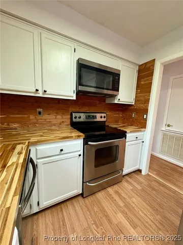 a kitchen with a stove and a microwave