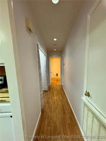 a view of a hallway with wooden floor