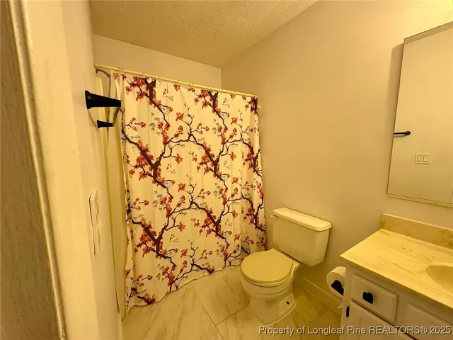 a white toilet sitting next to a bathroom sink