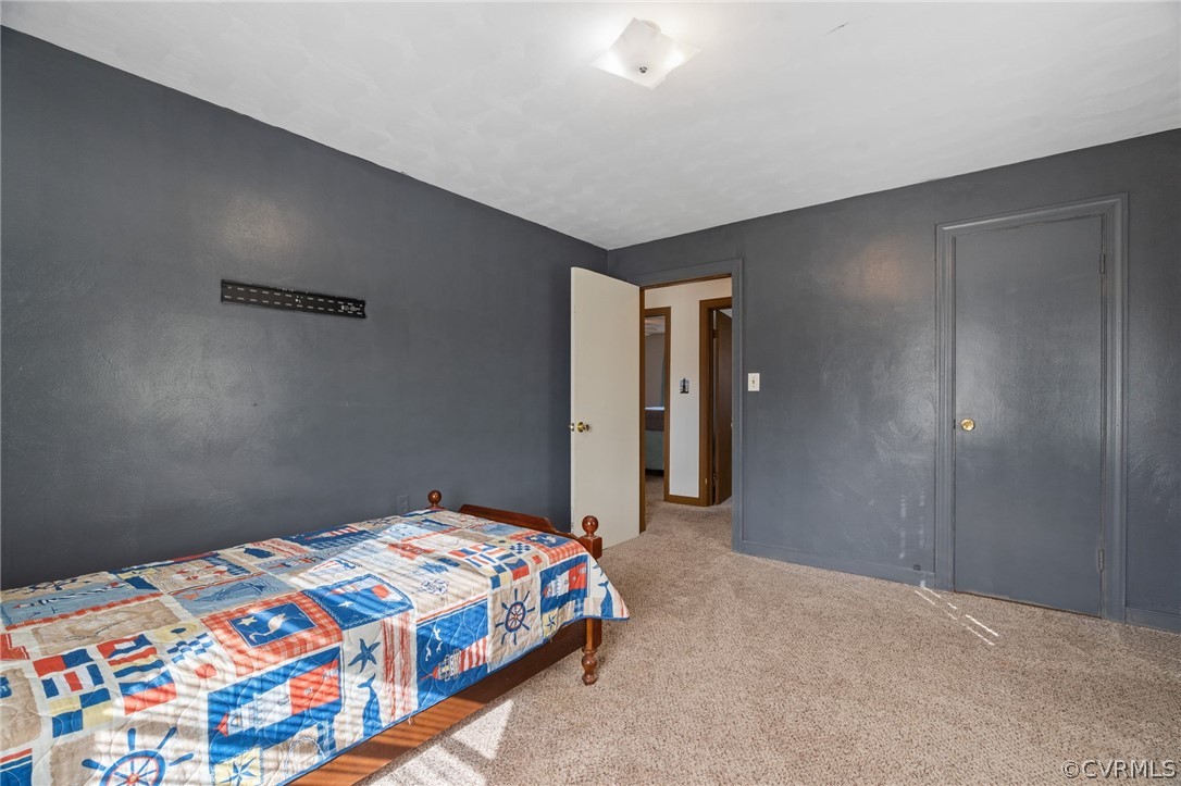 2859 East River Road Cardinal, VA 23025 - Photo 13 of 33 a bedroom with a bed and a lamp