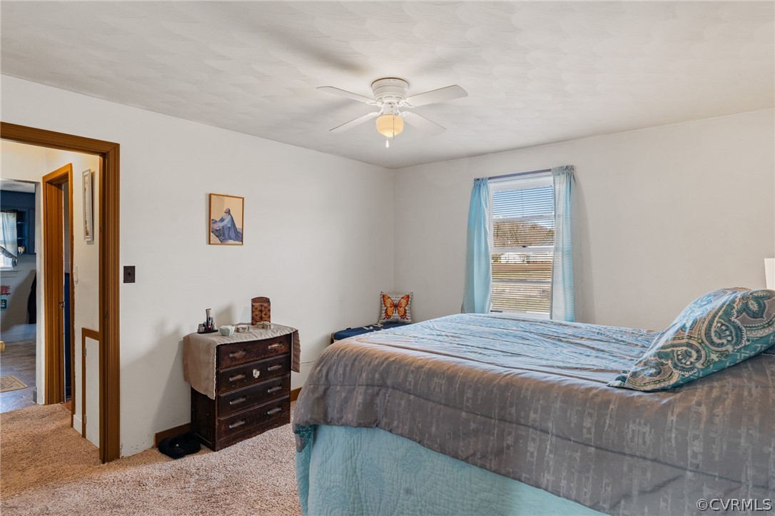 2859 East River Road Cardinal, VA 23025 - Photo 16 of 33 a bedroom with a bed and a chandelier