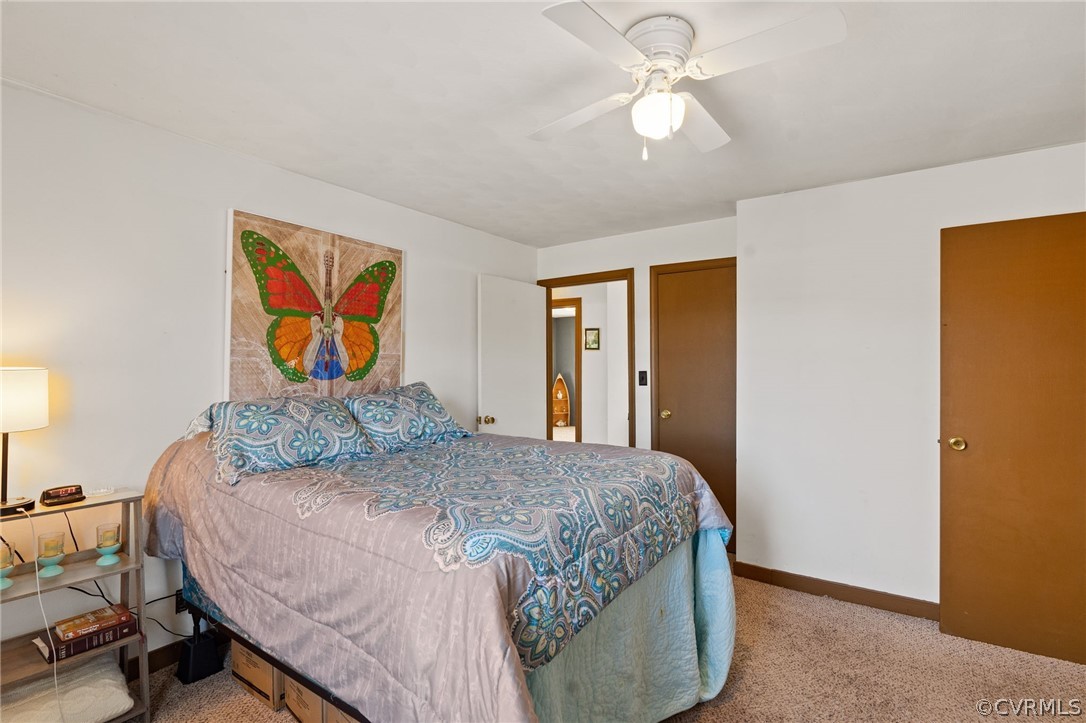 2859 East River Road Cardinal, VA 23025 - Photo 17 of 33 a bedroom with a bed and a chandelier