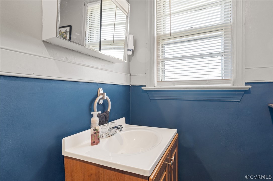 2859 East River Road Cardinal, VA 23025 - Photo 22 of 33 a bathroom with a sink a vanity and a window