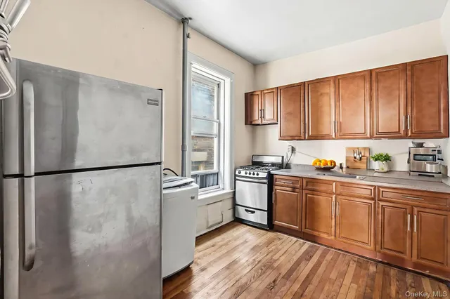 a kitchen with stainless steel appliances granite countertop a refrigerator sink and cabinets