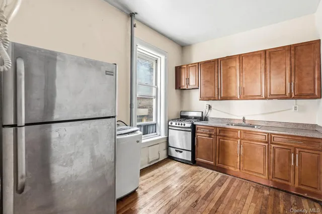 a kitchen with stainless steel appliances granite countertop a refrigerator sink and cabinets