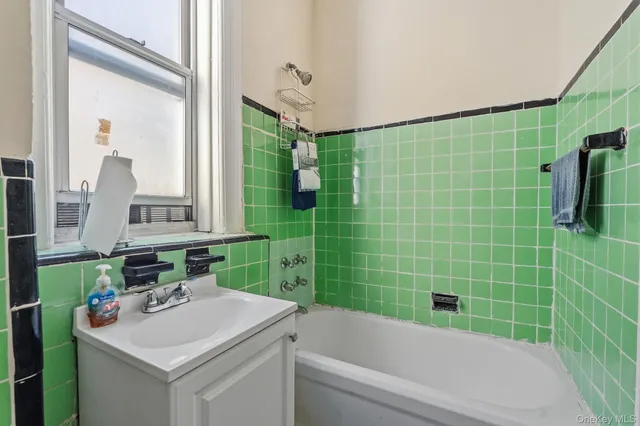 a bathroom with a sink mirror toilet and bathtub