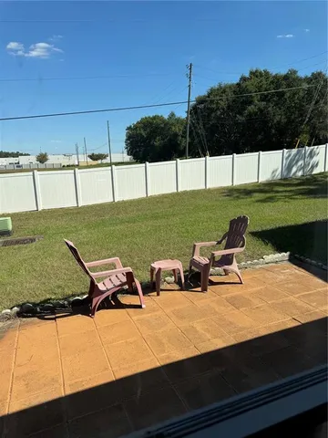 a view of a lake with lawn chairs