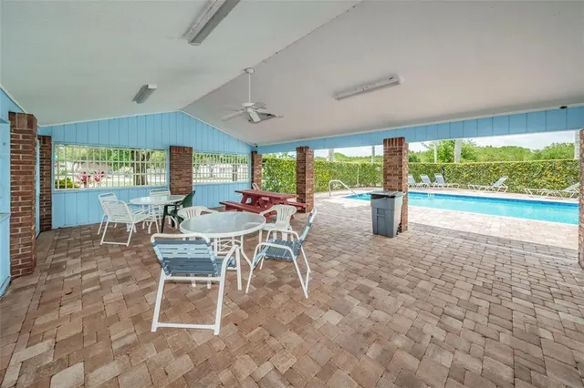 a room with patio furniture and a wooden floor