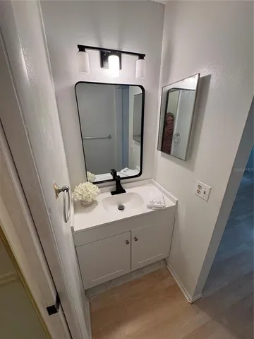 a view of a room with wooden floor