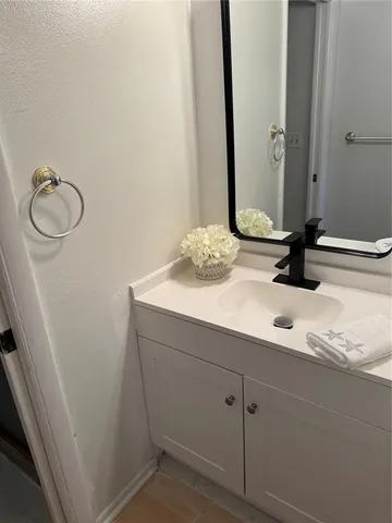 a kitchen with a sink a refrigerator and cabinets