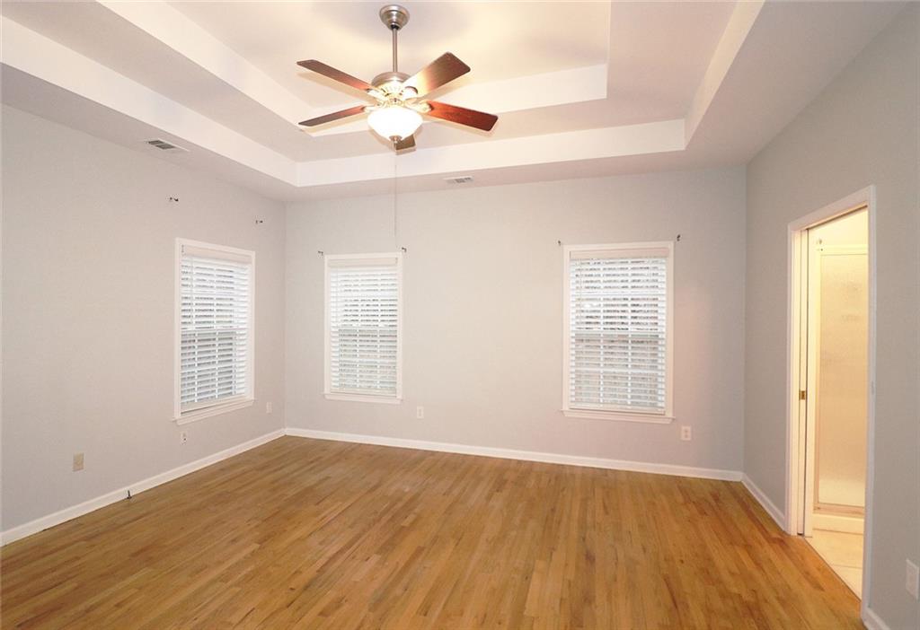 100 Wiley Hills Trail Woodstock, GA 30188 - Photo 14 of 39 an empty room with wooden floor and windows