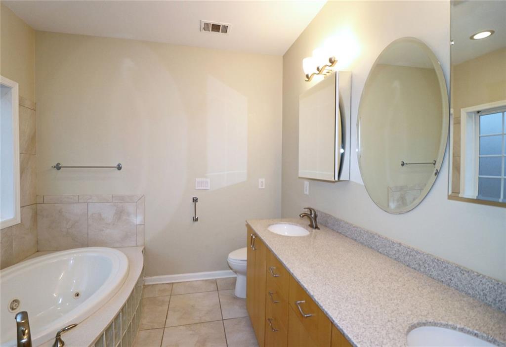 100 Wiley Hills Trail Woodstock, GA 30188 - Photo 18 of 39 a bathroom with a granite countertop sink a toilet and bathtub