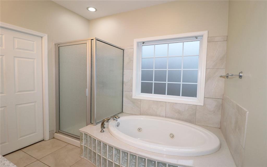 100 Wiley Hills Trail Woodstock, GA 30188 - Photo 20 of 39 a bathroom with a tub and shower