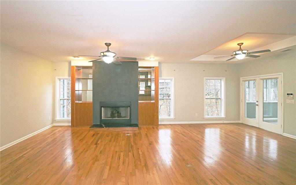 100 Wiley Hills Trail Woodstock, GA 30188 - Photo 3 of 39 a view of an empty room with wooden floor and a window