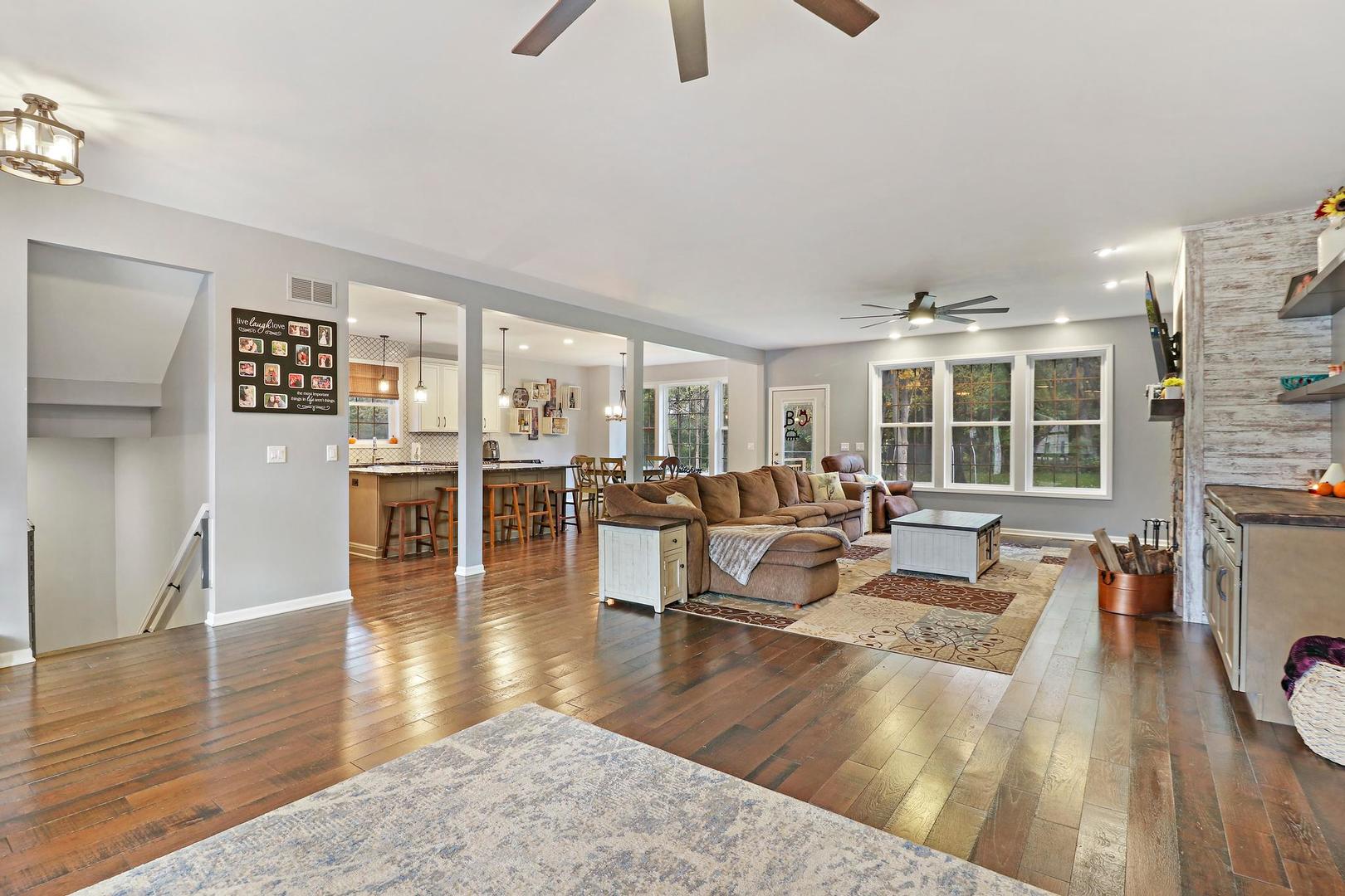 39247 Rangers Way Antioch, IL 60002 - Photo 11 of 33 a living room with furniture large window and wooden floor