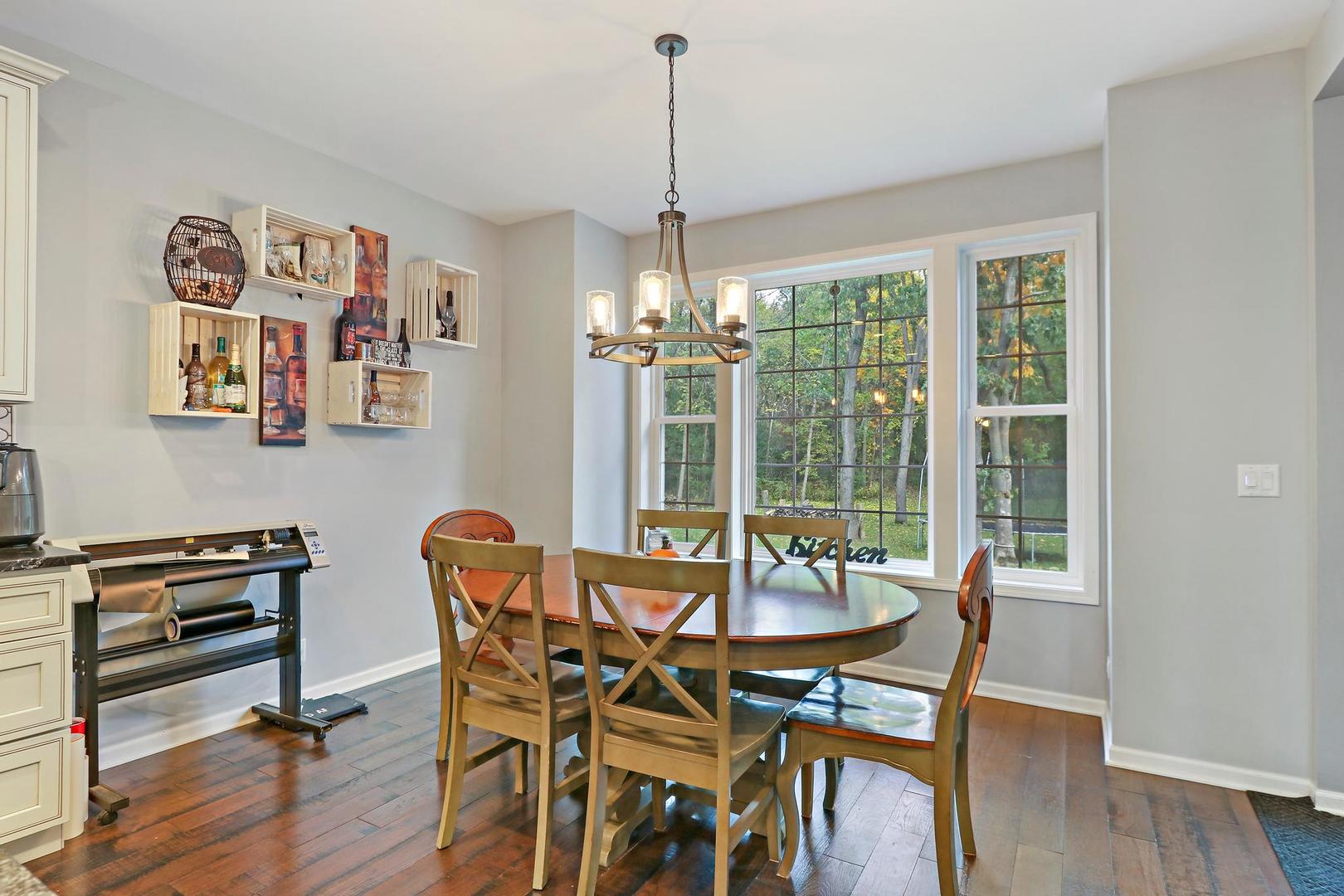 39247 Rangers Way Antioch, IL 60002 - Photo 14 of 33 a dining room with furniture a chandelier and wooden floor