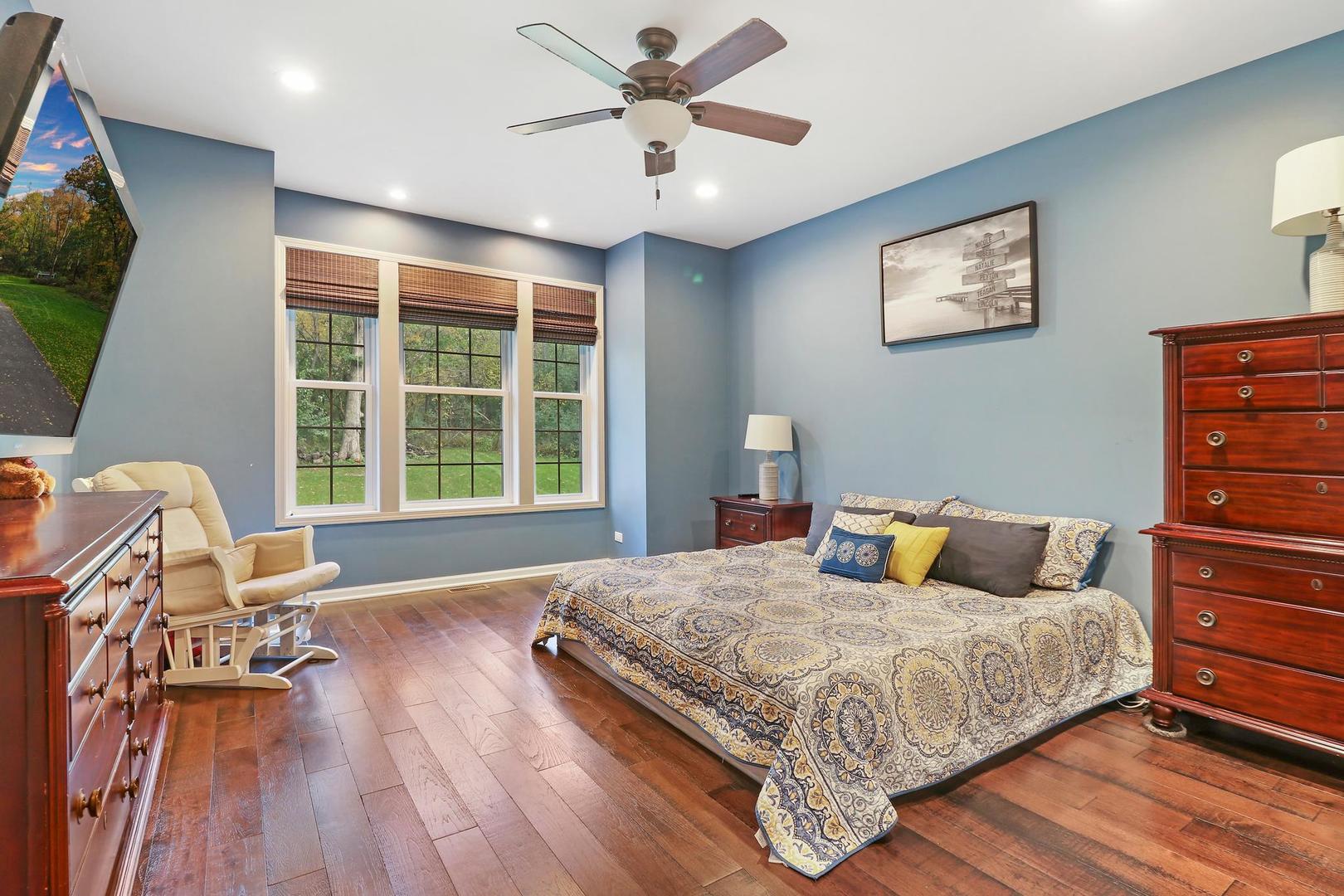39247 Rangers Way Antioch, IL 60002 - Photo 16 of 33 a bedroom with a bed and wooden floor