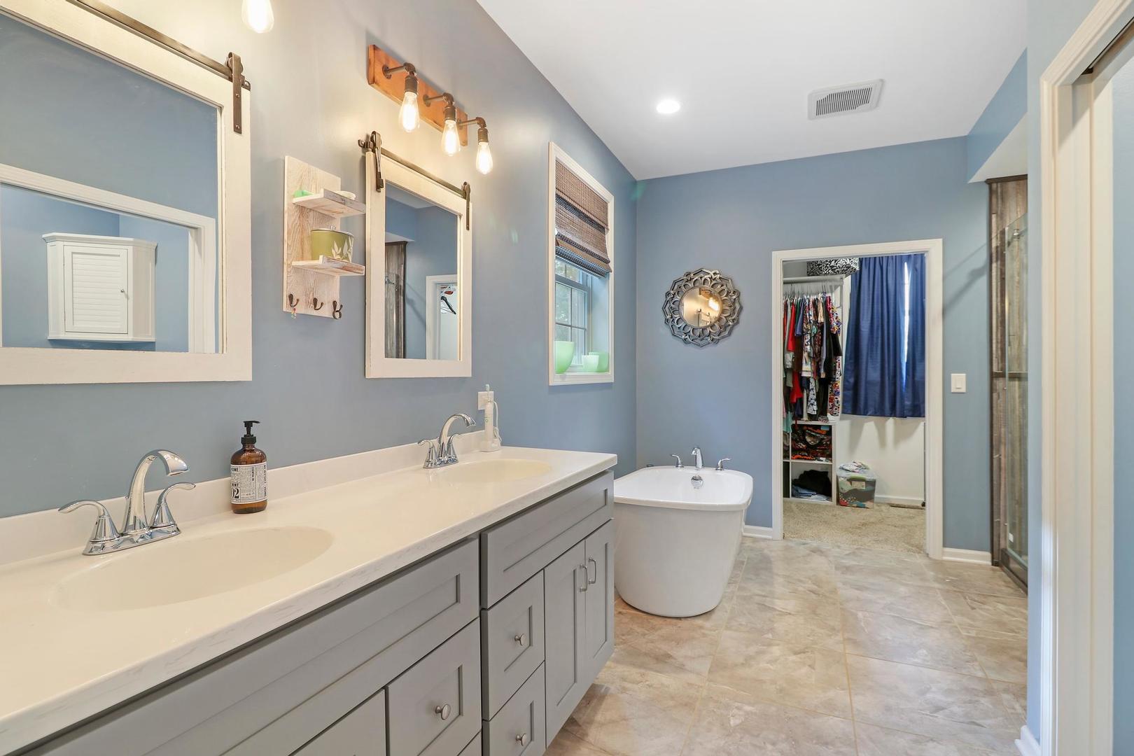 39247 Rangers Way Antioch, IL 60002 - Photo 18 of 33 a spacious bathroom with a double vanity sink a toilet and a mirror