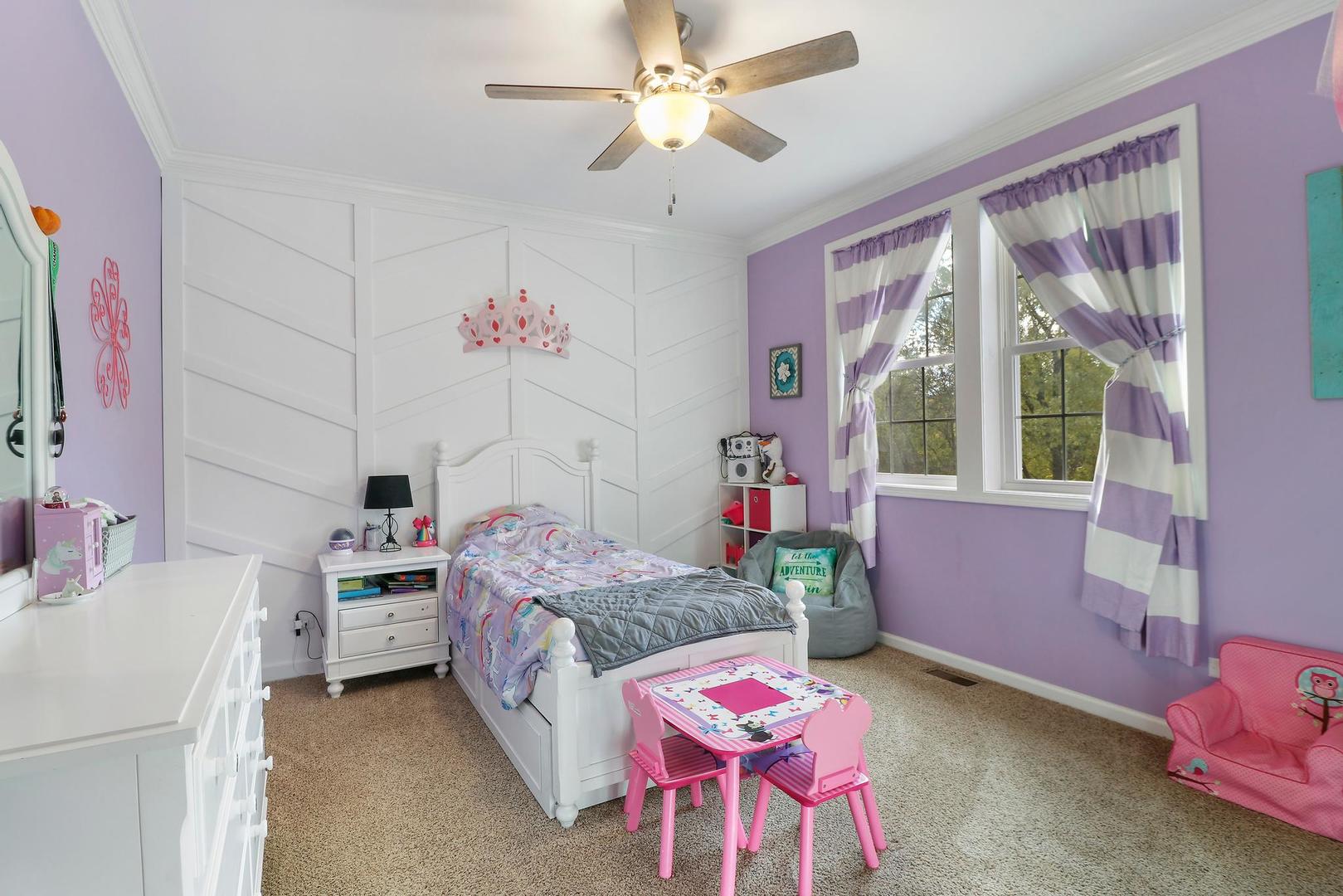 39247 Rangers Way Antioch, IL 60002 - Photo 23 of 33 a bedroom with a bed and a chandelier