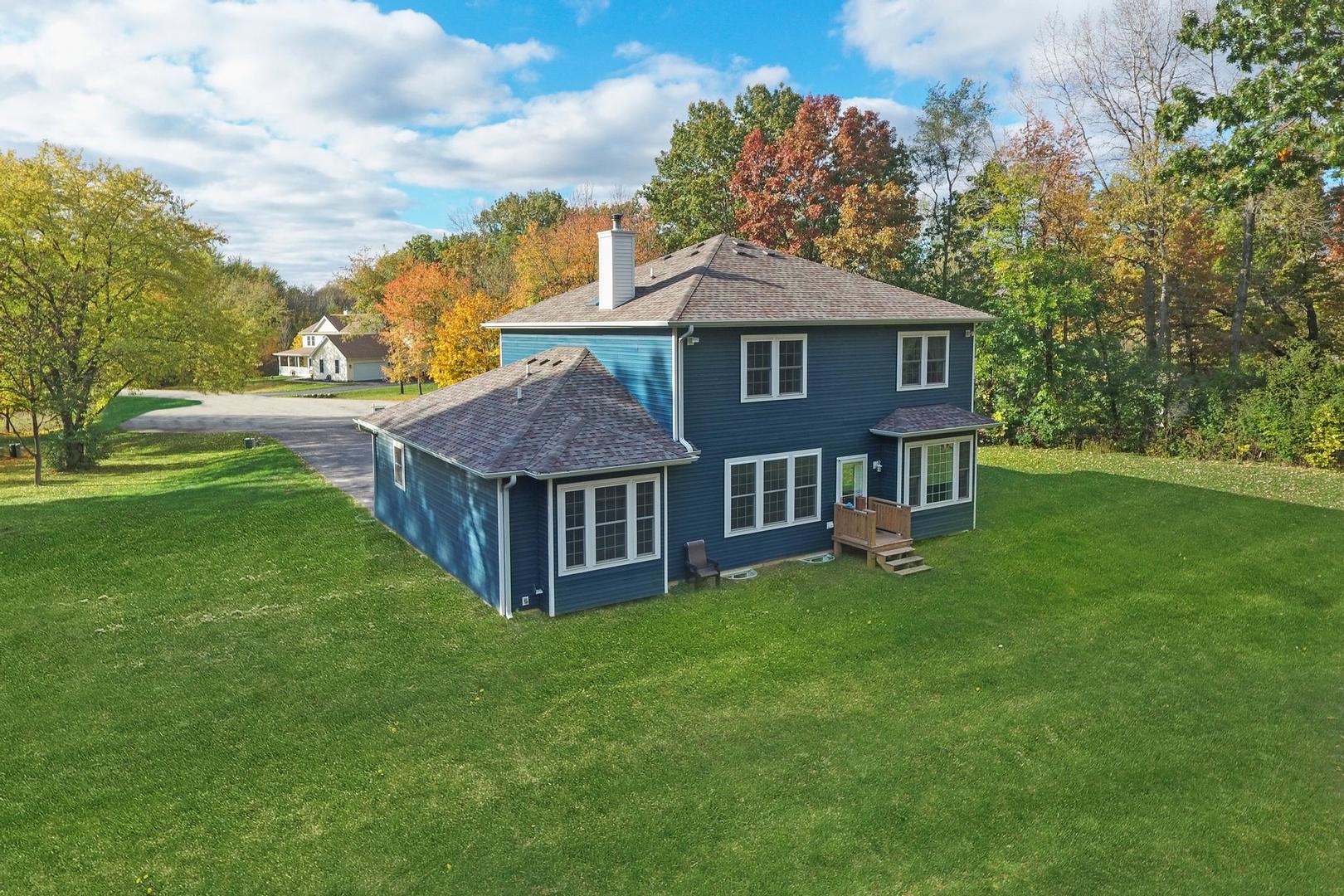 39247 Rangers Way Antioch, IL 60002 - Photo 6 of 33 a view of a house with a yard potted plants and large tree
