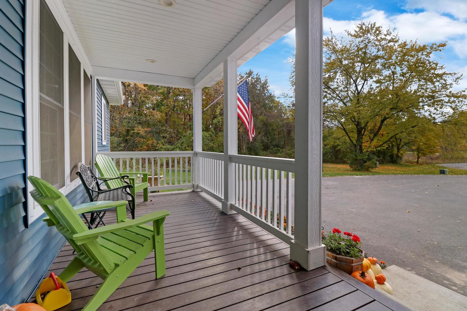 39247 Rangers Way Antioch, IL 60002 - Photo 9 of 33 a balcony with wooden floor table and chairs