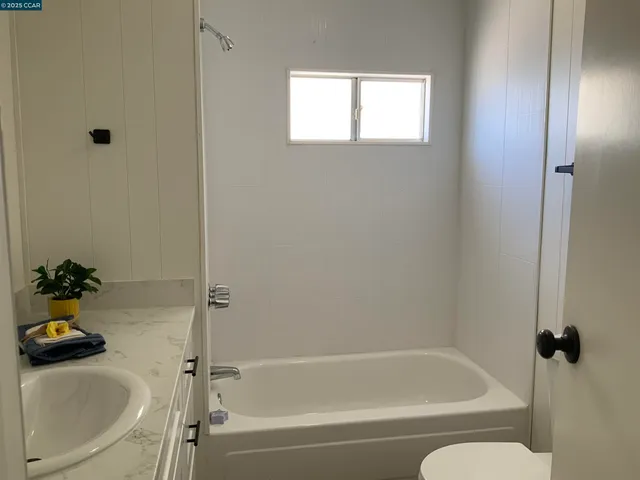 a bath room with a bath tub and a sink