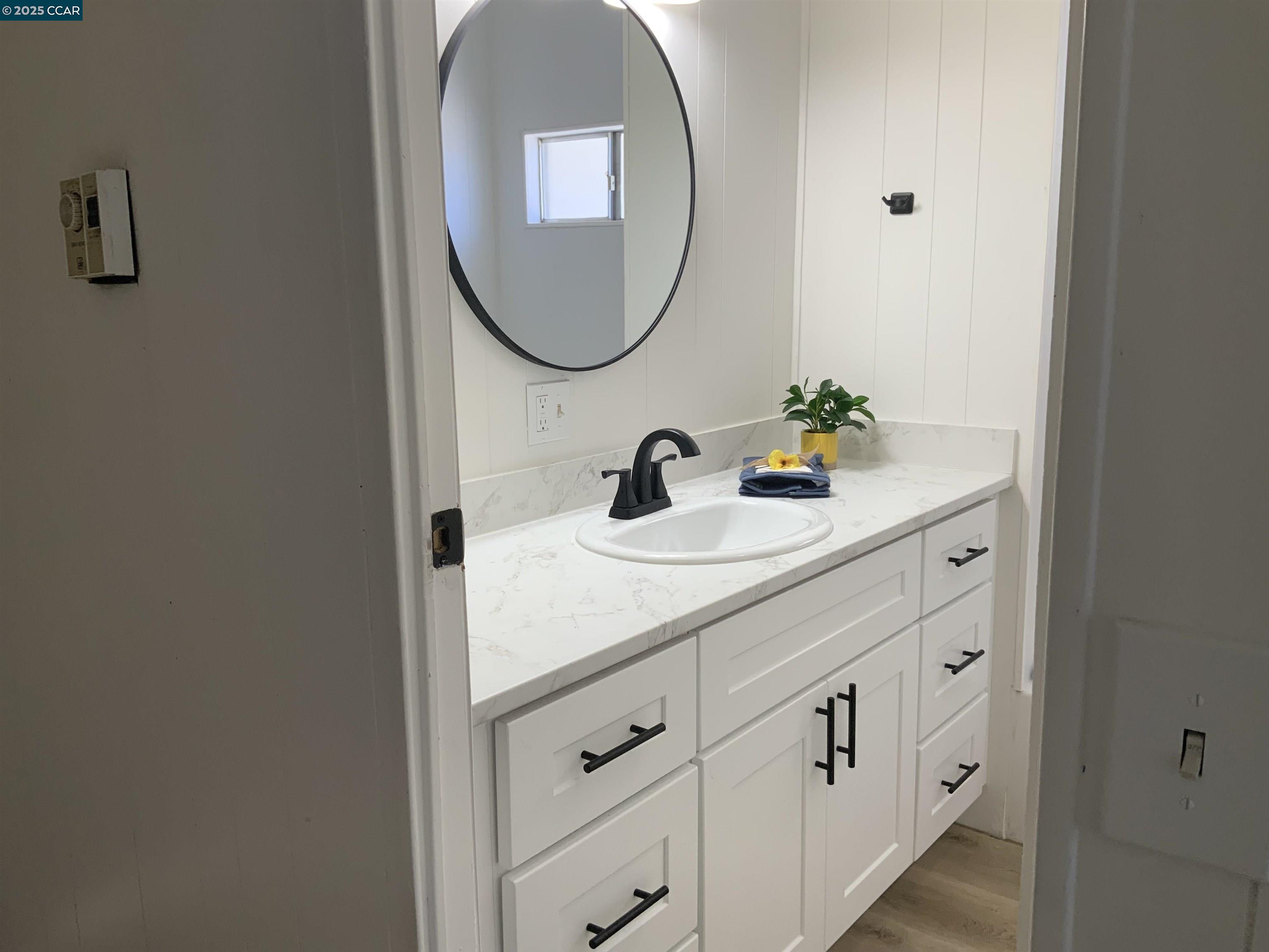 165 Tiki Lane Pittsburg, CA 94565 - Photo 20 of 28 a bathroom with a sink and a mirror