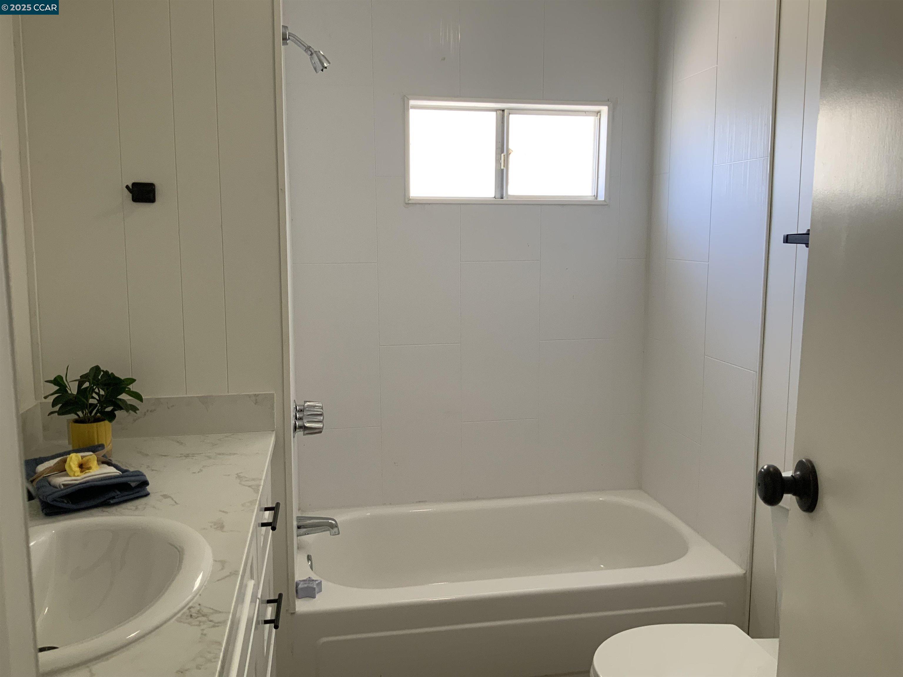 165 Tiki Lane Pittsburg, CA 94565 - Photo 27 of 28 a bath room with a bath tub and a sink