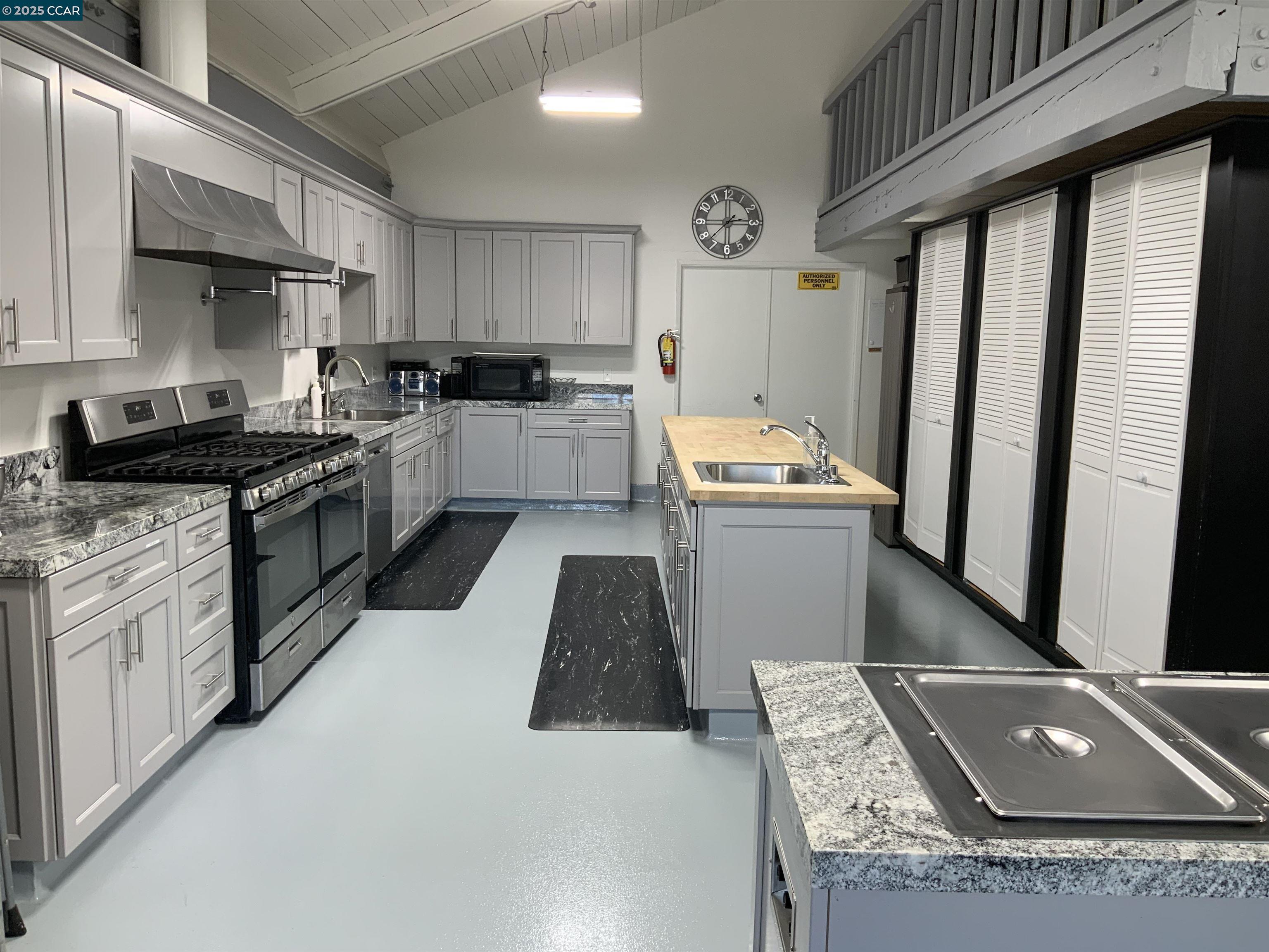 165 Tiki Lane Pittsburg, CA 94565 - Photo 5 of 28 a kitchen with granite countertop a sink stainless steel appliances and cabinets