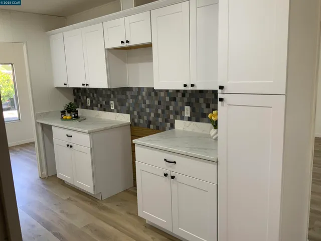 a kitchen with a sink and cabinets