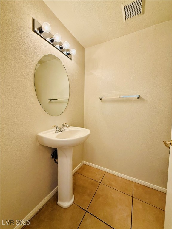 10231 Deerfield Beach Avenue, Unit 103 Las Vegas, NV 89129 - Photo 14 of 31 Bathroom featuring light tile patterned floors, a textured wall, and a textured ceiling