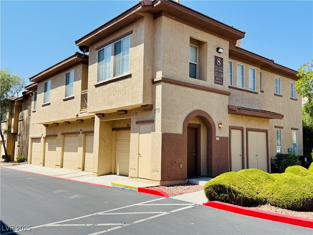 10231 Deerfield Beach Avenue, Unit 103 Las Vegas, NV 89129 - Photo 2 of 31 View of property with an attached garage