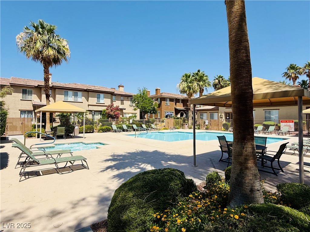 10231 Deerfield Beach Avenue, Unit 103 Las Vegas, NV 89129 - Photo 27 of 31 Community pool featuring a gazebo, a patio area, and a residential view