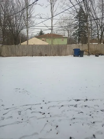 a view of yard covered with snow