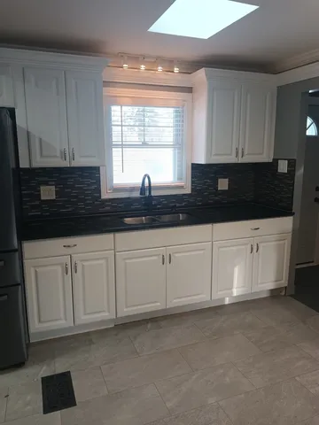 a kitchen with a sink and cabinets