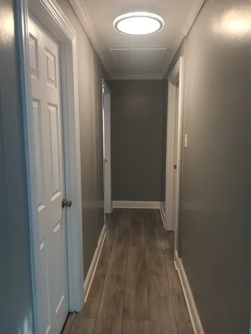 a view of a hallway with wooden floor