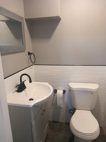 a white toilet sitting next to a bathroom sink