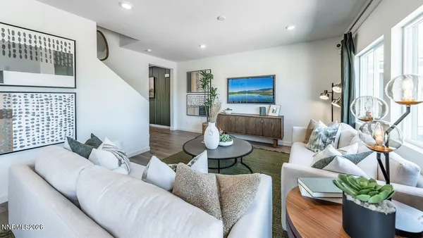 a living room with furniture and a potted plant