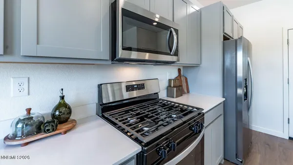 a kitchen with stainless steel appliances granite countertop a stove and a microwave