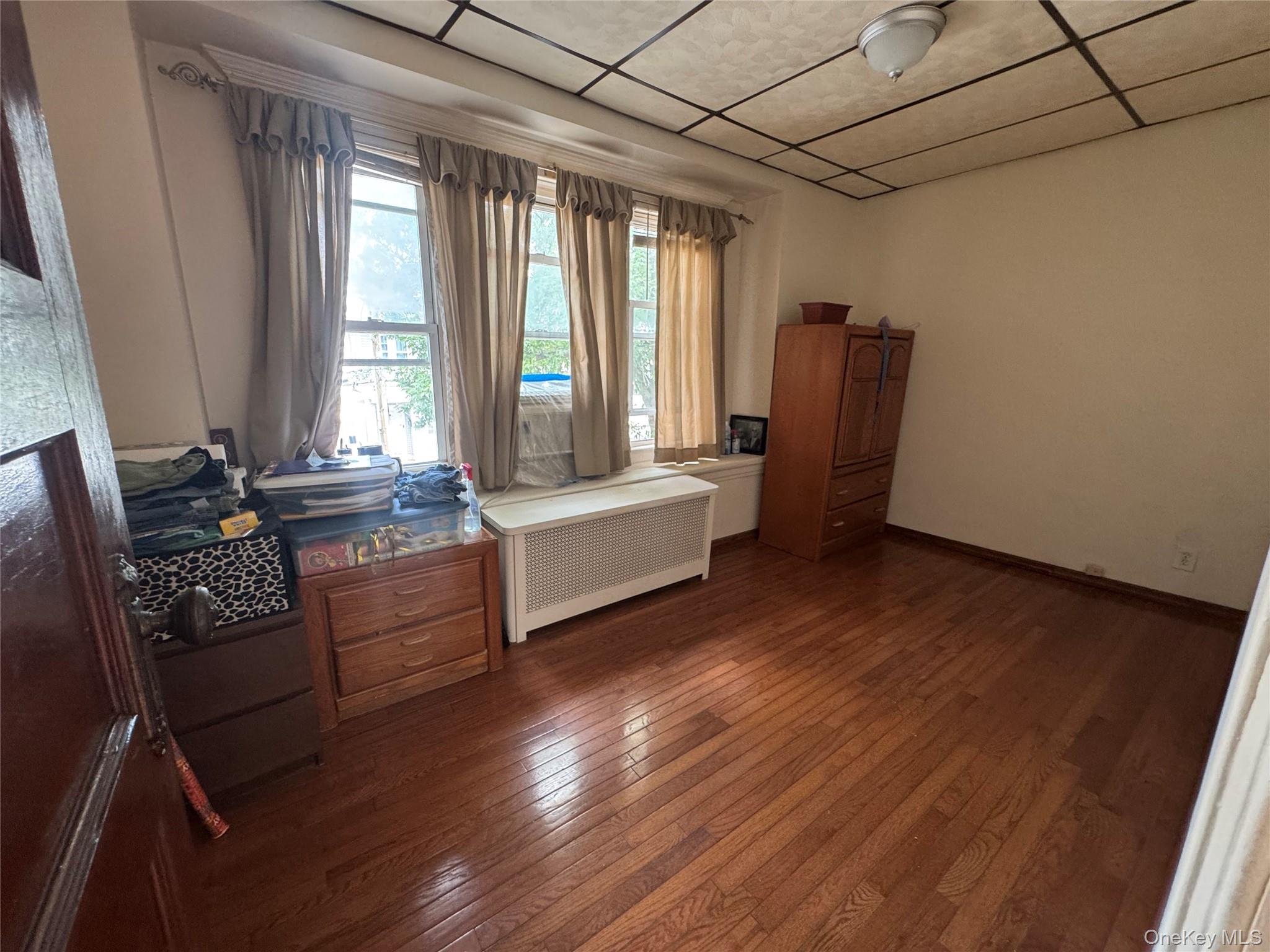 80-58 88th Road Queens, NY 11421 - Photo 16 of 21 a living room with furniture and large windows