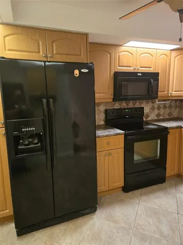 a view of a utility room with cabinets
