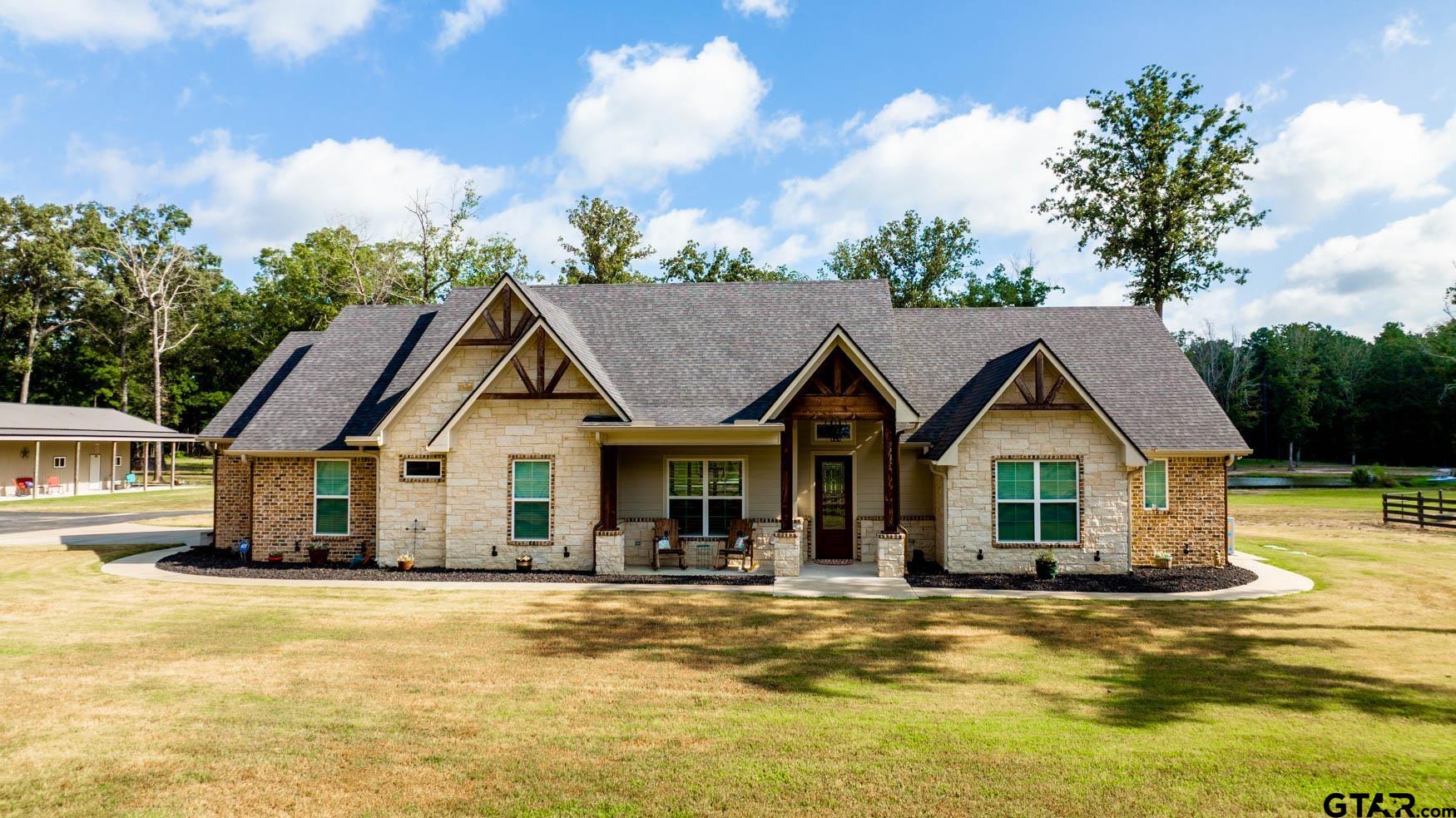 a front view of a house with a garden and porch