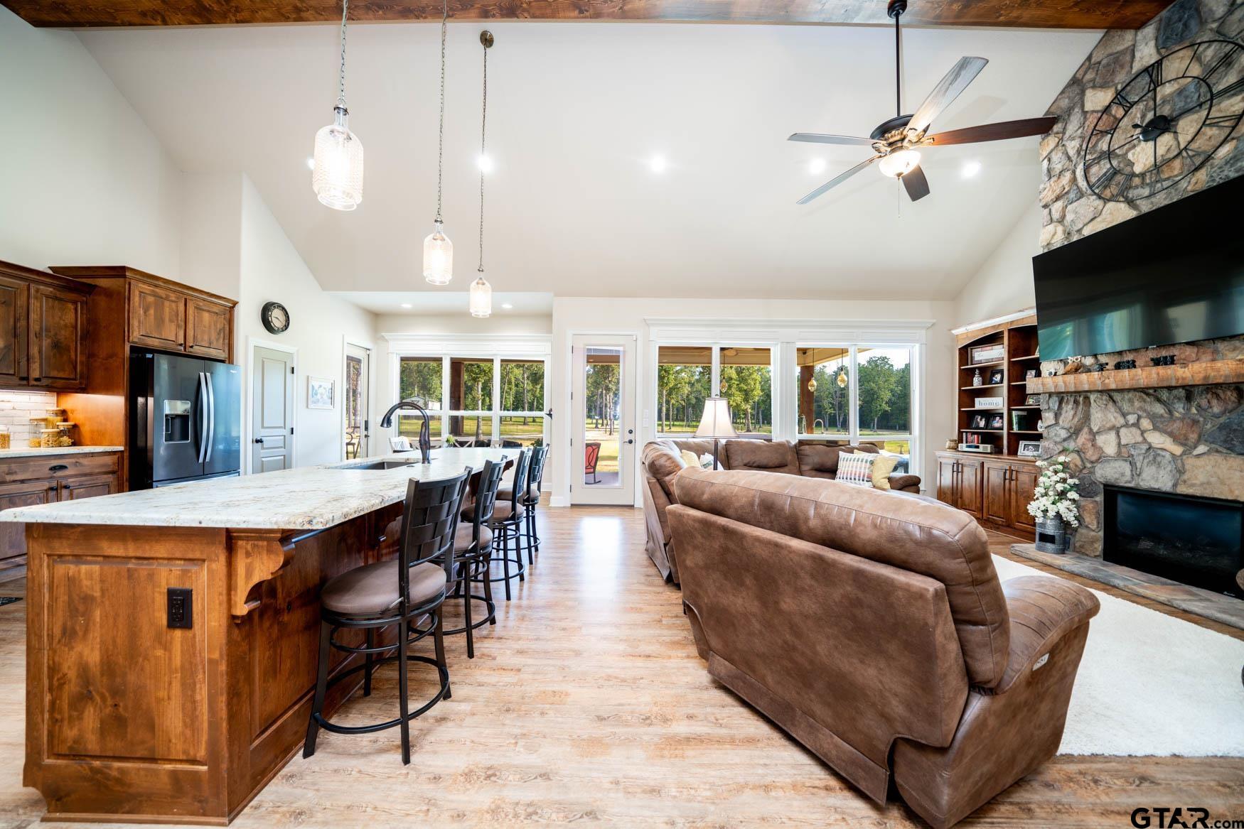 343 Driskell Bridge Road Harleton, TX 75651 - Photo 11 of 42 a living room with furniture a flat screen tv and a fireplace
