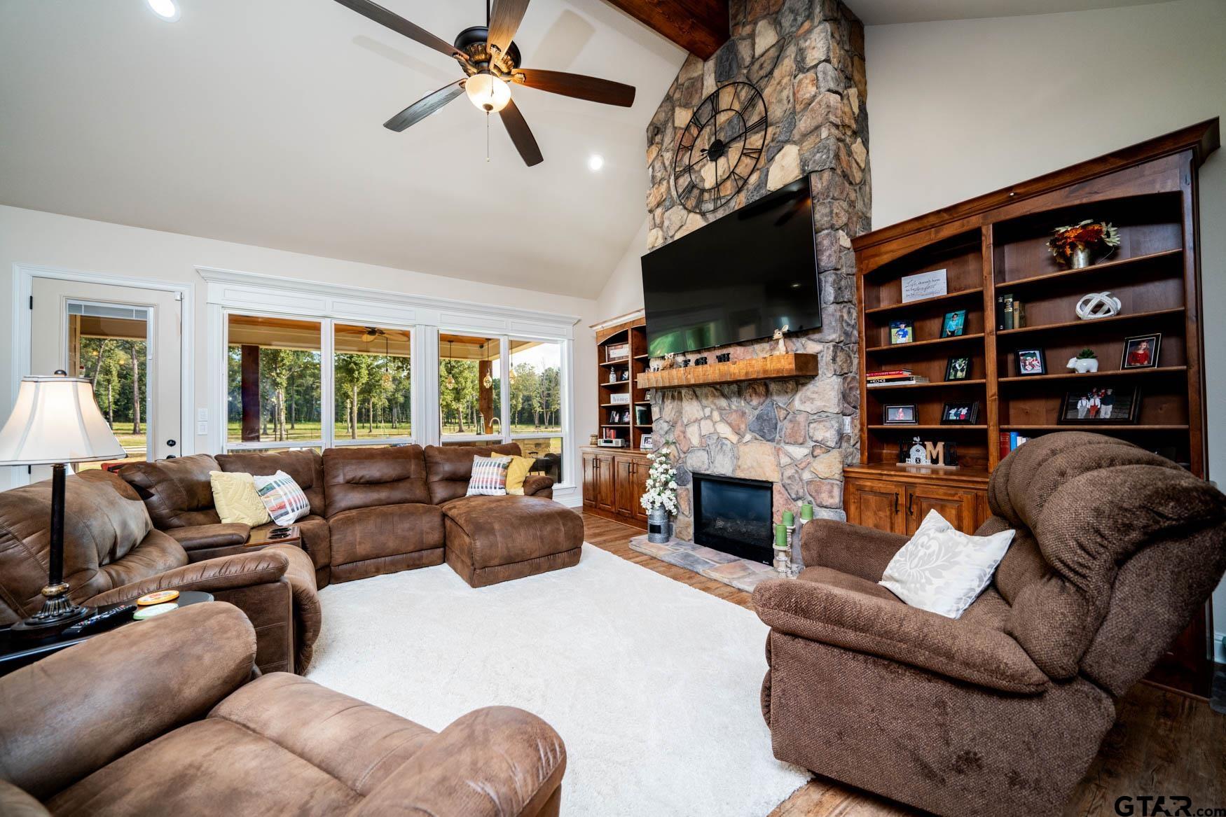 343 Driskell Bridge Road Harleton, TX 75651 - Photo 12 of 42 a living room with furniture a fireplace and a flat screen tv