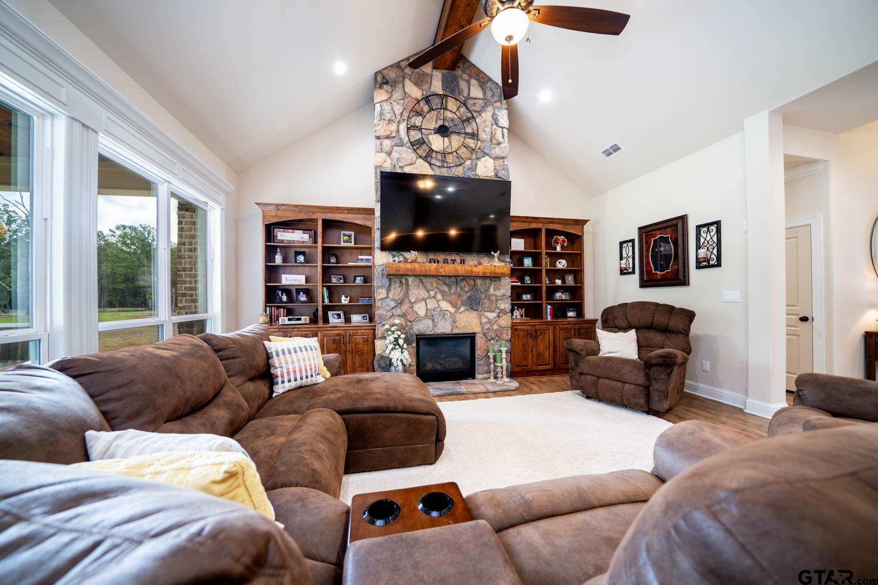 343 Driskell Bridge Road Harleton, TX 75651 - Photo 13 of 42 a living room with furniture a fireplace and a flat screen tv