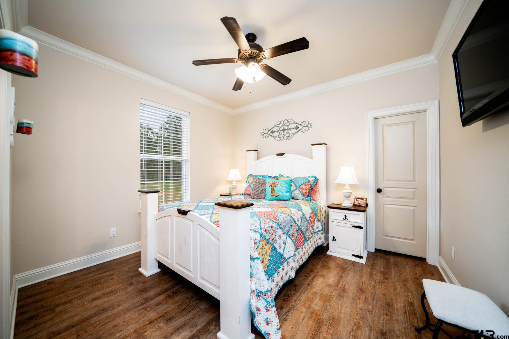 343 Driskell Bridge Road Harleton, TX 75651 - Photo 20 of 42 a bedroom with a bed and a flat screen tv