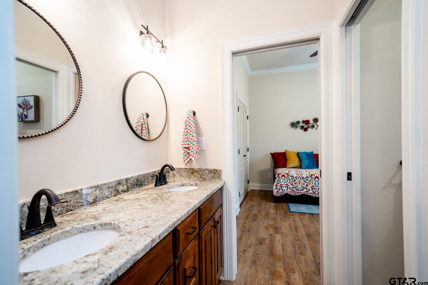 343 Driskell Bridge Road Harleton, TX 75651 - Photo 22 of 42 a bathroom with a granite countertop sink and a mirror