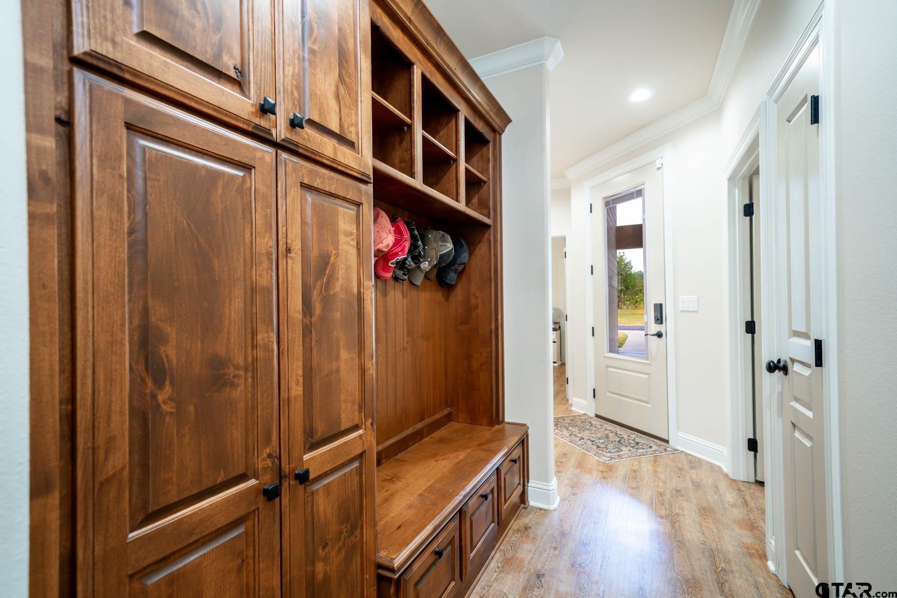 343 Driskell Bridge Road Harleton, TX 75651 - Photo 26 of 42 a view of a hallway with wooden floor and staircase