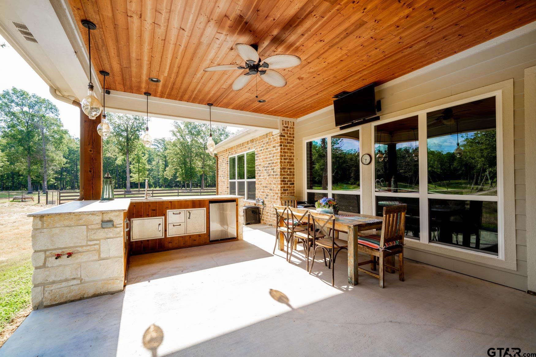 343 Driskell Bridge Road Harleton, TX 75651 - Photo 27 of 42 a view of a patio with a dining table and chairs