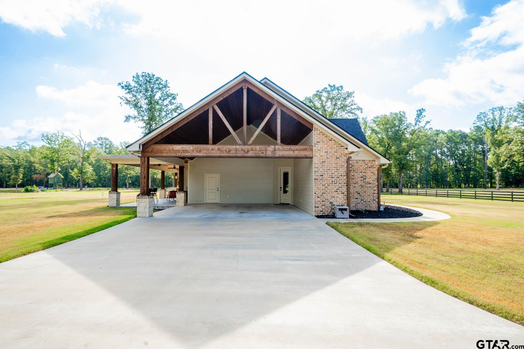 343 Driskell Bridge Road Harleton, TX 75651 - Photo 29 of 42 a view of house and outdoor space with swimming pool